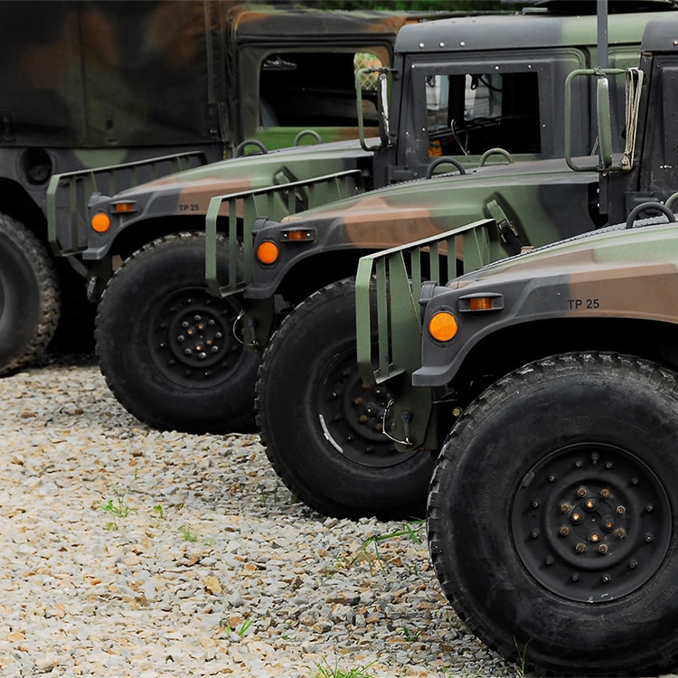 A picture a lineup of humvees located at Asymmetric Solutions
